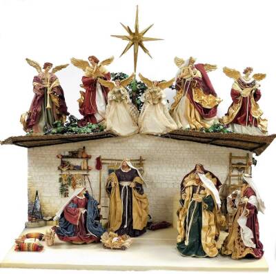 A Golden Treasures Nativity set, the plaster base depicting courtyard scene, with Tree of Life to rear, under a stable with six angels with the Jerusalem Star, four playing instruments, together with a group of figures to include The Three Kings, Mary, Jo