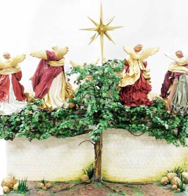 A Golden Treasures Nativity set, the plaster base depicting courtyard scene, with Tree of Life to rear, under a stable with six angels with the Jerusalem Star, four playing instruments, together with a group of figures to include The Three Kings, Mary, Jo - 6