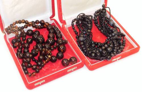 Two modern costume jewellery necklaces, to include an orange and black coloured beaded necklace, with a screw in clasp and matching clip on earrings converted from loose beads and an imitation jet multi row beaded necklace with similar clasp, both boxed.