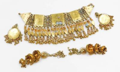 Eastern dress jewellery, to include a brass multi row set choker, with rectangular panels and drop tassels with bells, with matching clip on earrings, a pair of three tiered Indian filigree patterned brass clip on earrings. (3) - 5