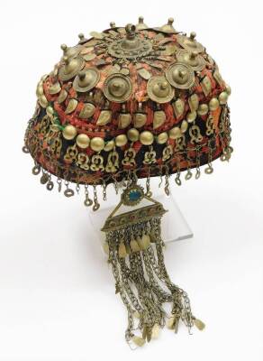 A group of Kailash wedding items, to include a red hat with paste stone drop gold string design set with beads, a cream beaded hat attached fan, a multicoloured wicker storage basket and an Eastern wedding dress set with hat and shirt drops. (a quantity) - 3