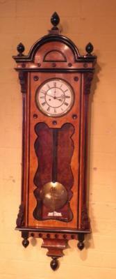 A 19thC burr walnut and ebonised vienna wall clock with enamelled