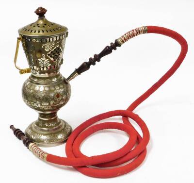 An Eastern shisha pipe, the main body in steel with a gold coloured coating, various piercing and engraving, on a steel body, with a wooden top, on a circular foot, the material pipe with wooden ends, and a gold coloured carrying handle, 53cm high.