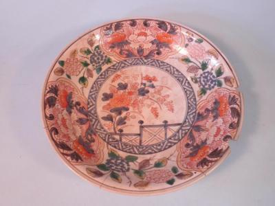 An 18thC Japanese Imari saucer dish decorated with flowers and