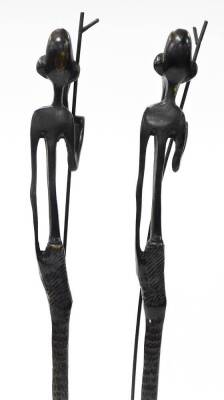 A pair of African bronze tribal sculptures, each of an elongated man with beard and walking stick, on a square tapered base, 66cm high, 6cm wide. (2) - 4