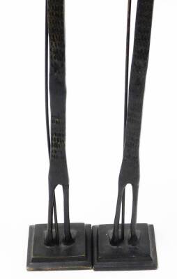 A pair of African bronze tribal sculptures, each of an elongated man with beard and walking stick, on a square tapered base, 66cm high, 6cm wide. (2) - 5