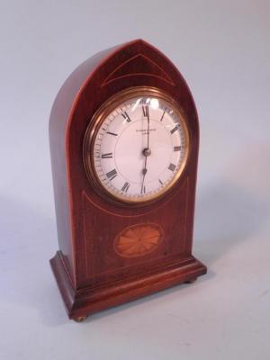 An Edwardian inlaid mahogany mantel timepiece with an arched case