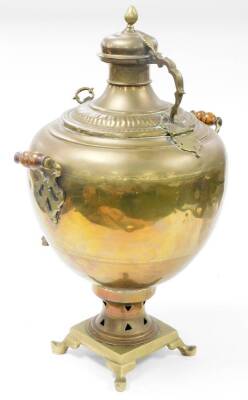 A 20thC copper and brass samovar, with front tap, shouldered body dome and a lid, on a pierced inverted stemmed foot, with turned wooden handles on splayed feet, 79cm high. - 2