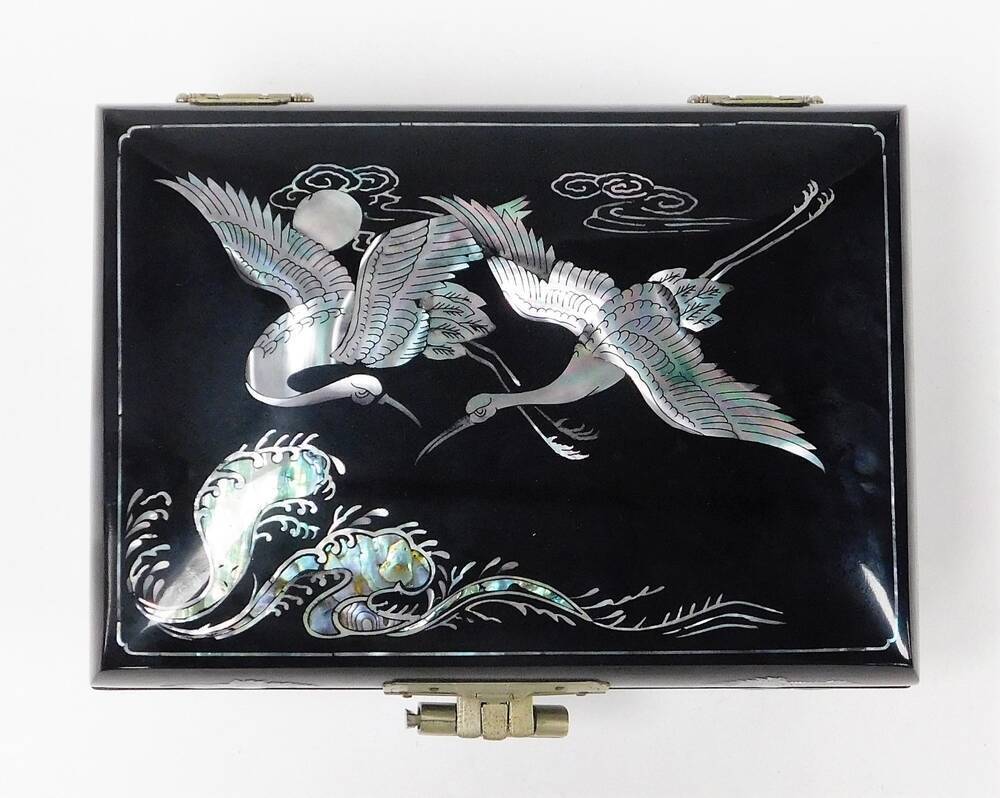 A Japanese red lacquer jewellery box, with mother of pearl inlay