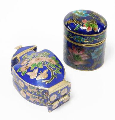 Two oriental cloisonné trinket boxes, the oval example with blue enamel cloisonné decoration on brass, depicting pink and blue flowers 4cm high with lift up lid, the imitation cloisonné urn shaped trinket box, with similar decoration 6cm high. (2)