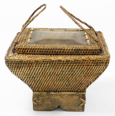 An Eastern wicker storage basket, shaped rectangular form, on a wooden base, with two carrying handles and lift up lid, 34cm high, 42cm wide. - 2