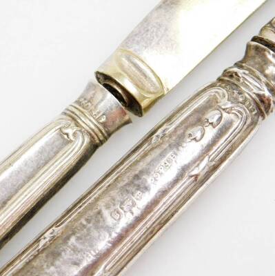 A group of silver six pences and two silver handled butter knives, comprising twenty two six pence pieces, a Birmingham assay silver handled butter knife, and another white metal butter knife unmarked. (a quantity) - 4