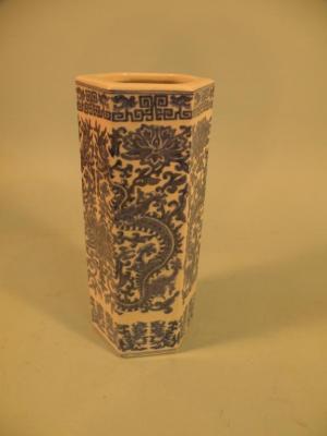 A Chinese hexagonal porcelain vase decorated with dragons and scrolls