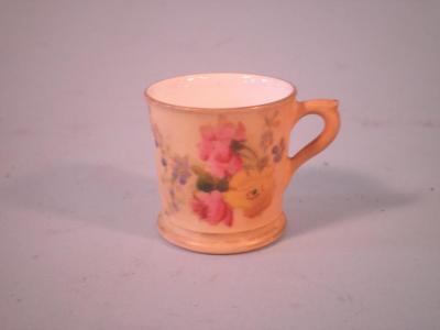 A Royal Worcester blush ivory miniature mug decorated with flowers