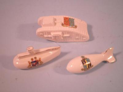 An Arcadian crested china model of a tank bearing the arms of Peterborough