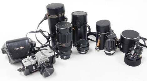 A group of camera lenses and cameras, to include a Miranda 1-3.5 lens, a Minolta 1-2 lens, a Vivitar 55mm lens, a Soligor Teleauto 1-3.5 lens, a Minolta Vectis 25 camera box and a Minolta SR1S camera in carry case, various other leather lens cases etc. (1