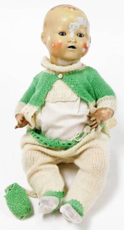 A German bisque headed doll, the head stamped BND London no.5, on a plastic body, full clothing, 46cm high. (AF)