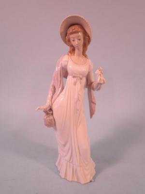 A Lladro porcelain figure of a lady wearing a white dress with cloth bag