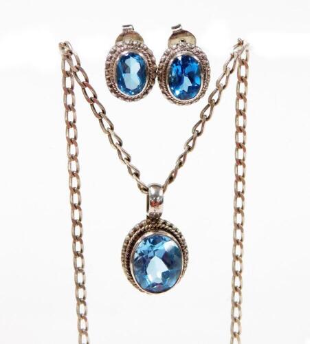 A Klimek earring and necklace set, each in silver with a central aquamarine coloured stone, with rope twist boarders, the pendant on a fancy link chain. (2)