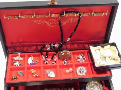 A black faux leather jewellery box and contents, comprising two gold plated dress rings, earrings, pin badges, beaded necklaces, etc. (a quantity) - 2