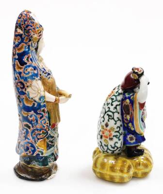 Three various early 20thC porcelain figures, comprising a standing Chinese lady holding scroll, polychrome decorate in blue and green robes, 28cm high, a figure of a bearded gentleman and two seated figures in flowing robes, polychrome decorated. (3, AF, - 5