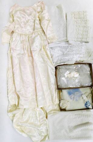 A quantity of linen and lace, to include lace tablecloths and place mats, a wedding gown and a wedding veil. (a quantity)