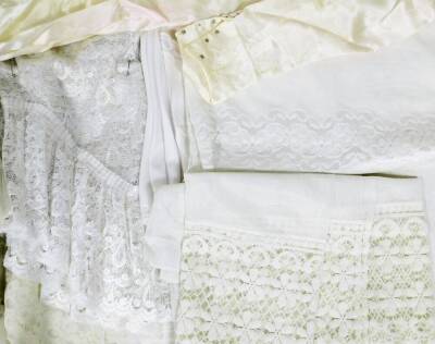 A quantity of linen and lace, to include lace tablecloths and place mats, a wedding gown and a wedding veil. (a quantity) - 2