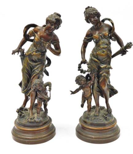 A pair of reproduction plaster figures, each of maidens with children, on a wooden base, stamped La Recompense and La Plus Belle Fleche, 48cm high.