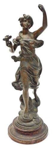 A late 19thC cast figure of a female, in dress with a flower, on a turned wooden base, 50cm high.