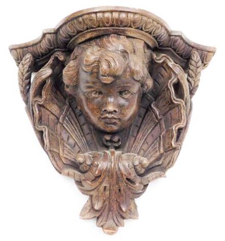 A terracotta wall shelf, with figure of a child and set with ferns and wheatsheaf, 27cm high, 29cm wide.