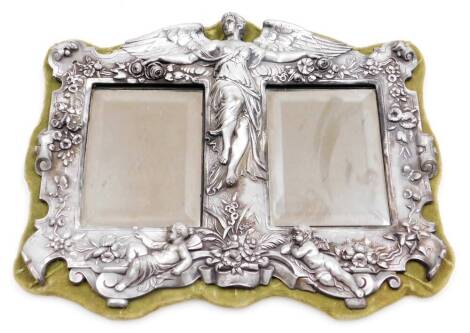 An Art Nouveau style pewter mirror, the outer border with floral and cherub decoration, bears signature for Ew Wyon, with two rectangular mirrored panels on a green velvet backing, 34cm x 27cm.