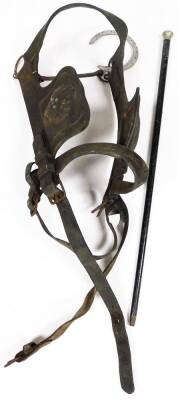 Leather horse blinkers, and a white metal topped walking cane. (2)