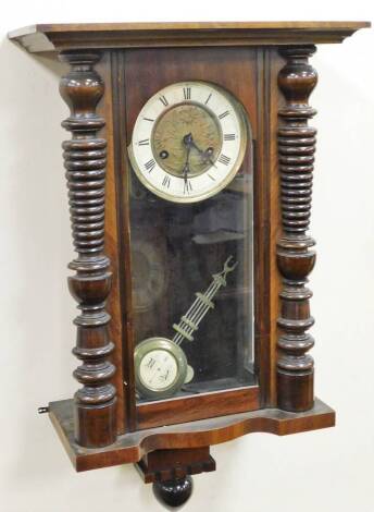 A late 19thC Vienna wall clock, with a cream and metal floral dial, with single pendulum drop, with a eight day movement, lacking cornice, 63cm high, 32cm wide, 16cm deep.