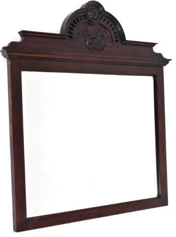 A walnut framed wall mirror, the moulded cornice top of oval form with scrolls and vines, with pierced fret work on a plain rectangular frame, 64cm x 70cm.