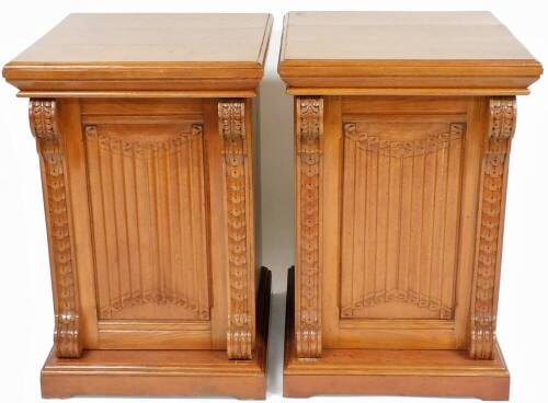 A pair of 19thC oak pedestal cupboards, each moulded top with S scroll and fan pillars, a carved central section, on a block base, the front door opening to reveal two shelves, 97cm high, 64cm wide, 66cm deep.