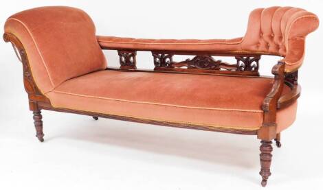 A Victorian mahogany chaise longue, with pierced back, upholstered in pink fabric, on turned legs, 82cm high, 172cm wide, 61cm deep.