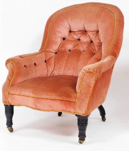 An Edwardian button back chair, in pink upholstered material with button back and corded banding on turned mahogany legs with casters, 90cm high, 67cm wide, 68cm deep.