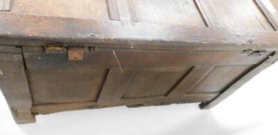 A late 17th/early 18thC oak coffer, the three panelled top section with metal hinges, on a carved two panel front with shield crest and sundial type decoration with a metal lock panel, 59cm high, 107cm wide, 50cm deep. - 3