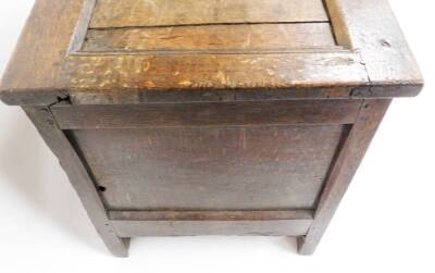 A late 17th/early 18thC oak coffer, the three panelled top section with metal hinges, on a carved two panel front with shield crest and sundial type decoration with a metal lock panel, 59cm high, 107cm wide, 50cm deep. - 5