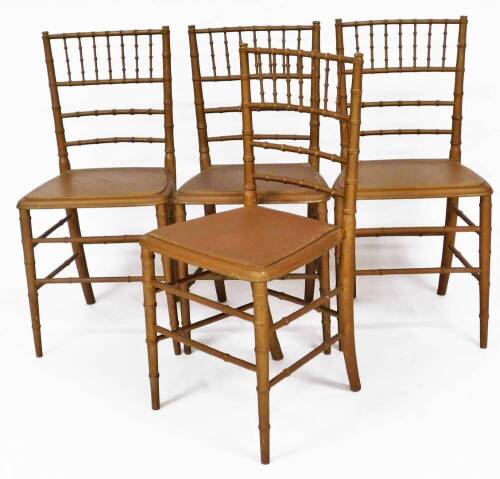 A set of four 19thC gold painted dining chairs, turned to simulate bamboo, 75cm high.