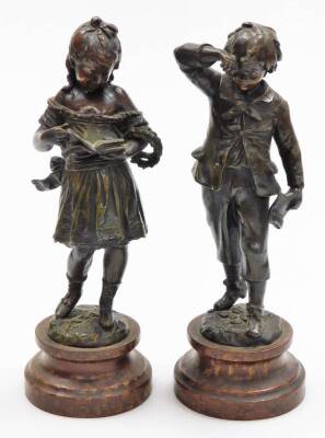 A pair of early 20thC resin figures of children, to include boy and girl on a wooden base, 31cm high. (2)