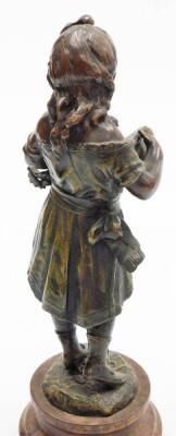 A pair of early 20thC resin figures of children, to include boy and girl on a wooden base, 31cm high. (2) - 5