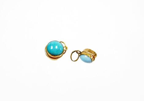 Two turquoise set pendants, each with stone to each side in a yellow metal frame, unmarked. (2)