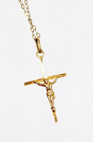 A 9ct gold crucifix pendant and chain, the chain AF, 0.9g all in.