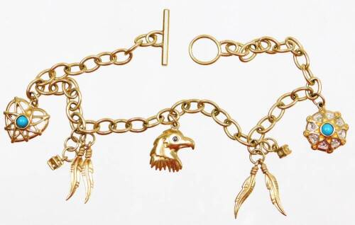 A charm bracelet, with various wings, eagles and charms some set with turquoise, yellow metal, unmarked, 21cm long overall.