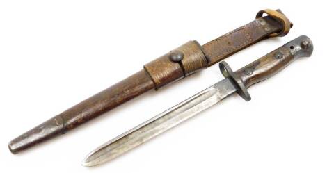 A bayonet, in leather scabbard, the blade numbered 1907, 39cm long.