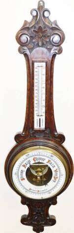 A late 19thC mahogany aneroid barometer, with carved flower design, marked Lloyd Paynet and Amiel Manchester, 87cm high.