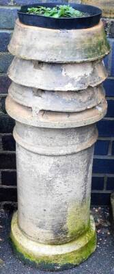 A Victorian stoneware chimney pot, the top with four sectioned cowel on a circular foot, 92cm high, 31cm wide.