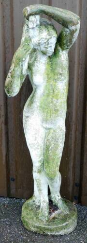 A reconstituted stone figure of a nude lady, on a circular base, 120cm high, 22cm wide.