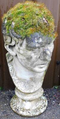 A stone half bust of Bacchus, on a small circular plinth, 65cm high.